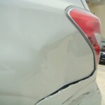 Before and after photographs of a damaged white Subaru that was repaired by Elite Paint & Body Shop in West Palm Beach, Florida
